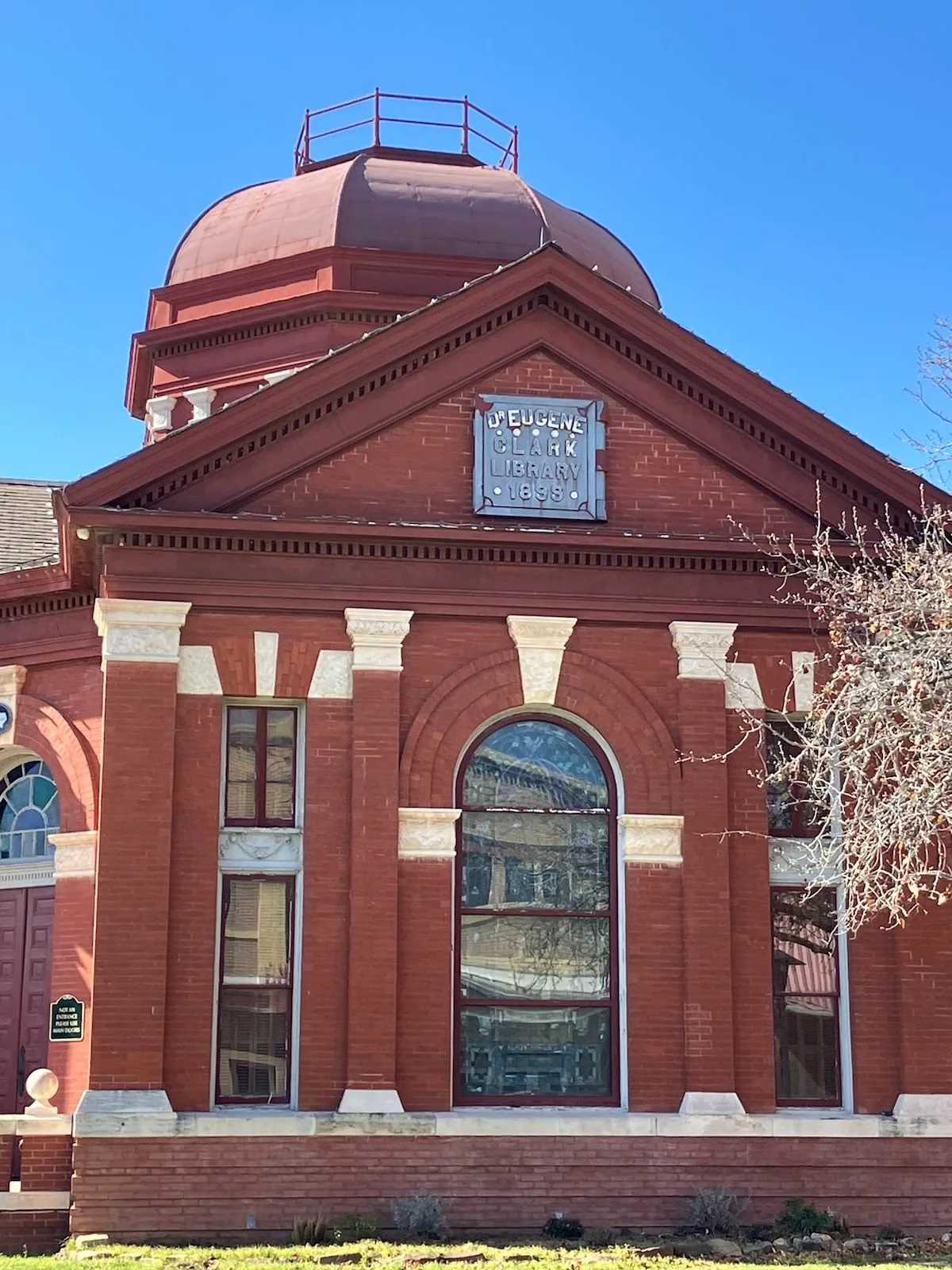 The 1899 pediment and arched window of the Dr. Eugene Clark Library